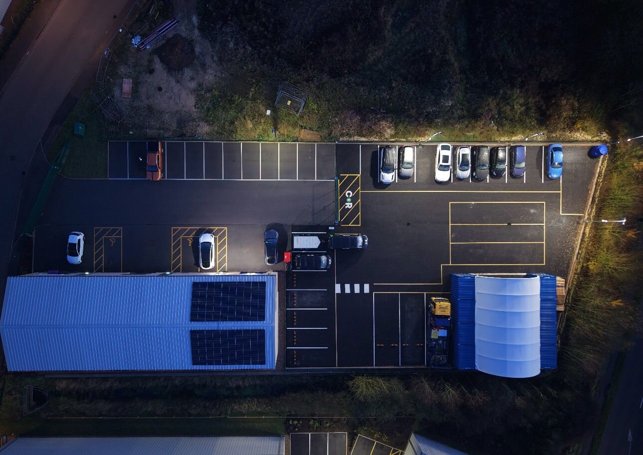 Aerial view of a car park freshly marked by C&R, showing rows of bays, the central aisle and hatched family bays