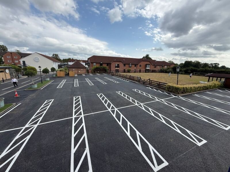 Freshly refurbished tarmac car park with crisp white echelon bay markings, by C&R