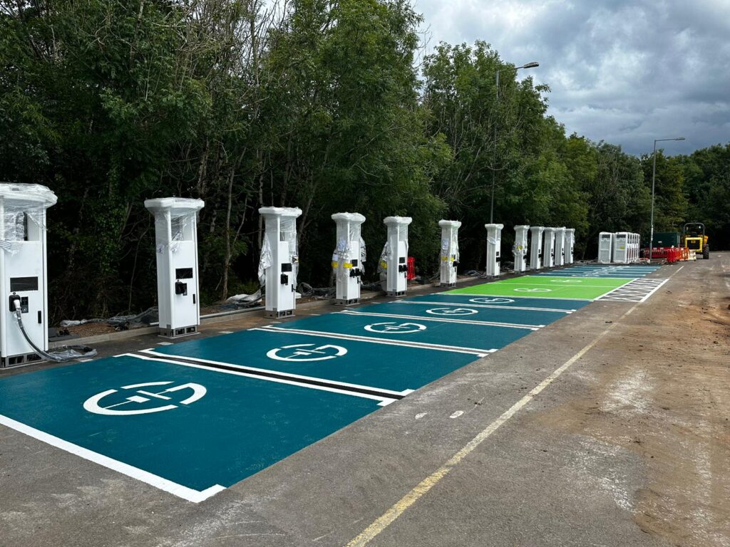 EV charging bay markings—green painted bays with EV symbols beside new charge points.